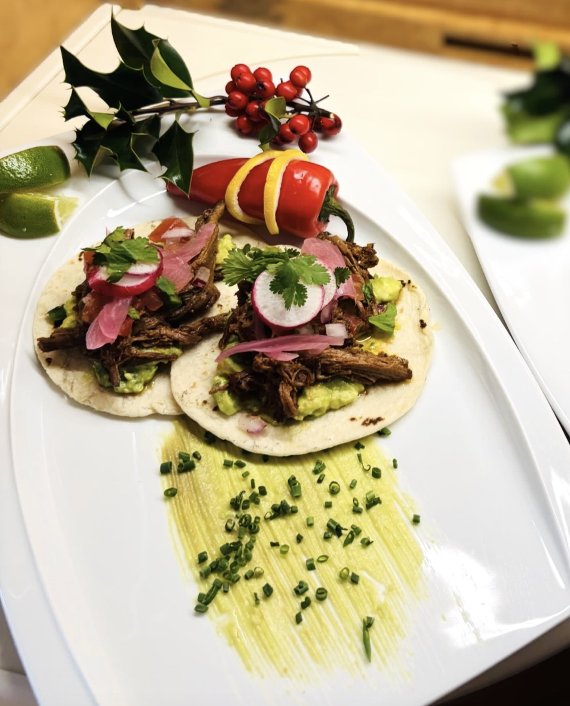 Street tacos plated with cilantro pickled onion and lime