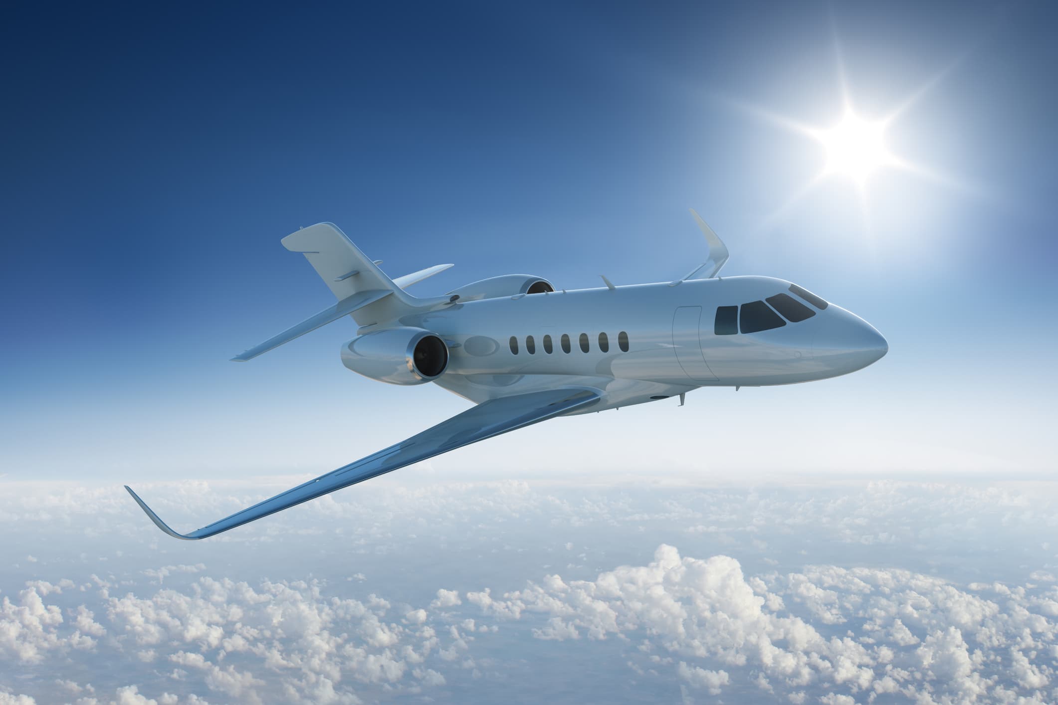 A private jet in flight high above the clouds